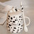 豪峰 创意马克杯陶瓷杯咖啡杯早餐杯牛奶杯卡通可爱水杯带盖勺(【黑色】【小斑点奶牛杯】【配盖勺】)第2张高清大图