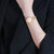 天梭（TISSOT）手表 弗拉明戈系列1853贝母石英表 瑞士时尚圆形女士钢带手表(T094.210.33.116.01)第4张高清大图